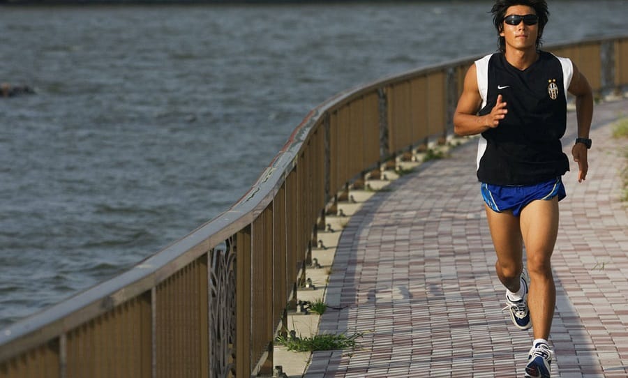 running man near lake